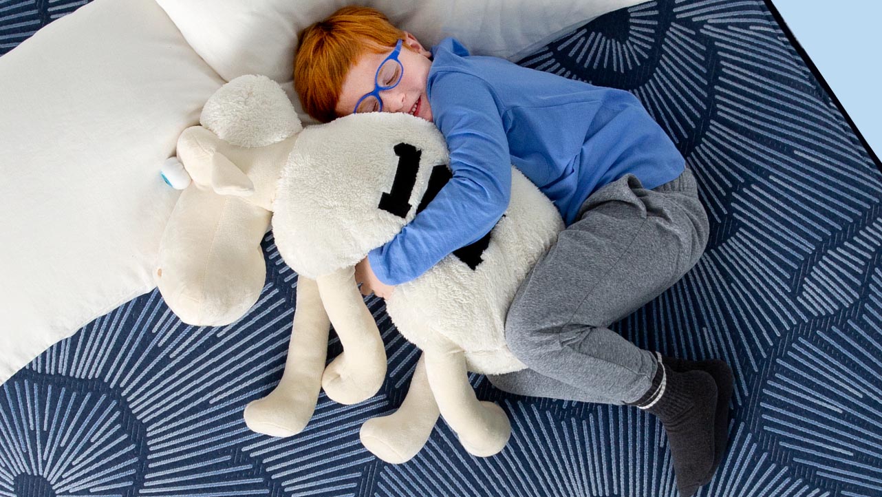 A woman sleeping on her stomach on a Serta mattress