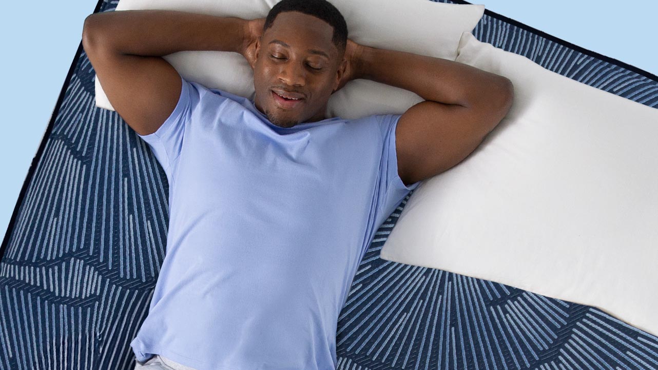 A couple with a small child sleeping on a Serta mattress in a bedroom